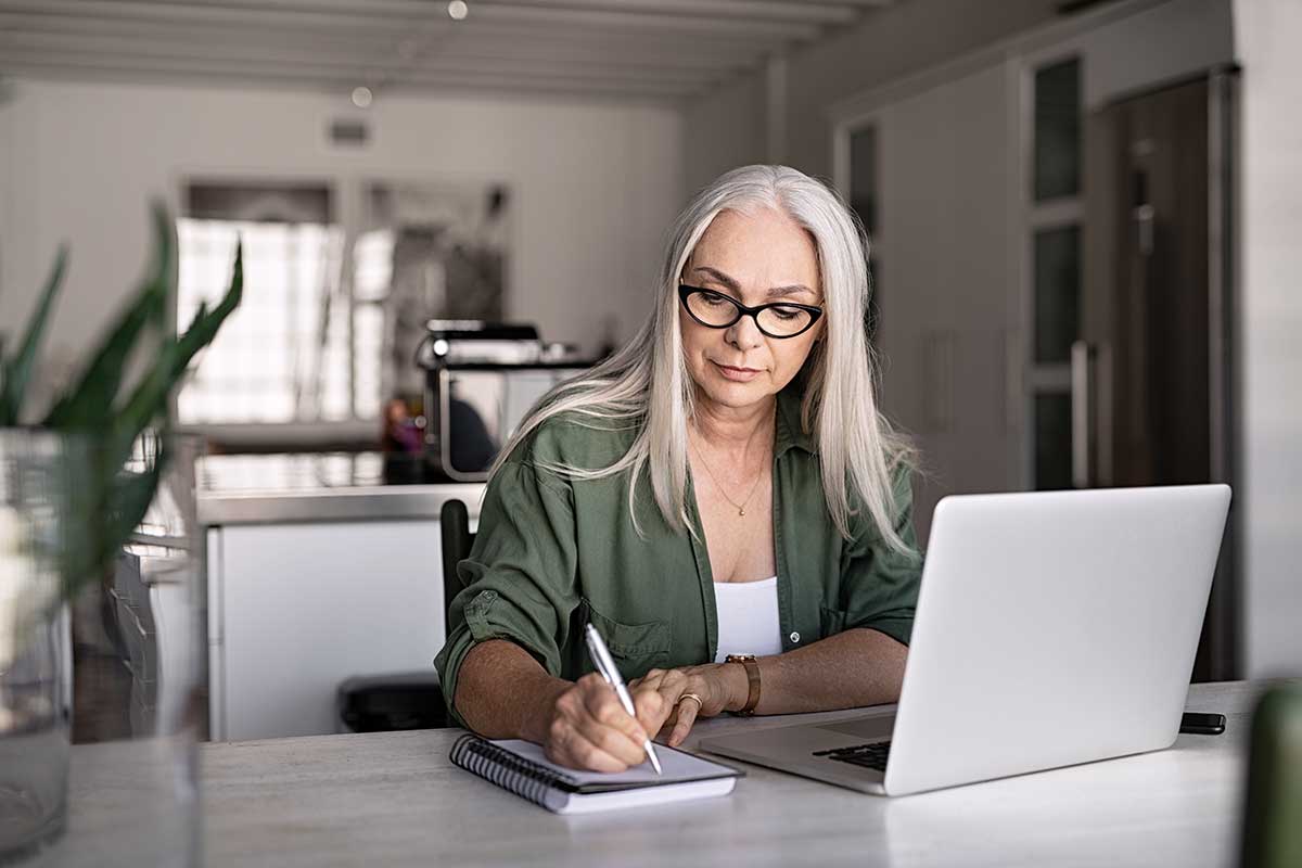 woman taking notes about managing remote teams